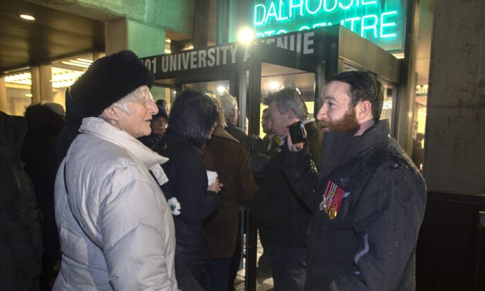 Jeremy MacKenzie (R) talks with an unidentified woman outside the venue where former child soldier Omar Khadr is speaking, in Halifax on Feb. 10, 2020. (The Canadian Press/Andrew Vaughan)
